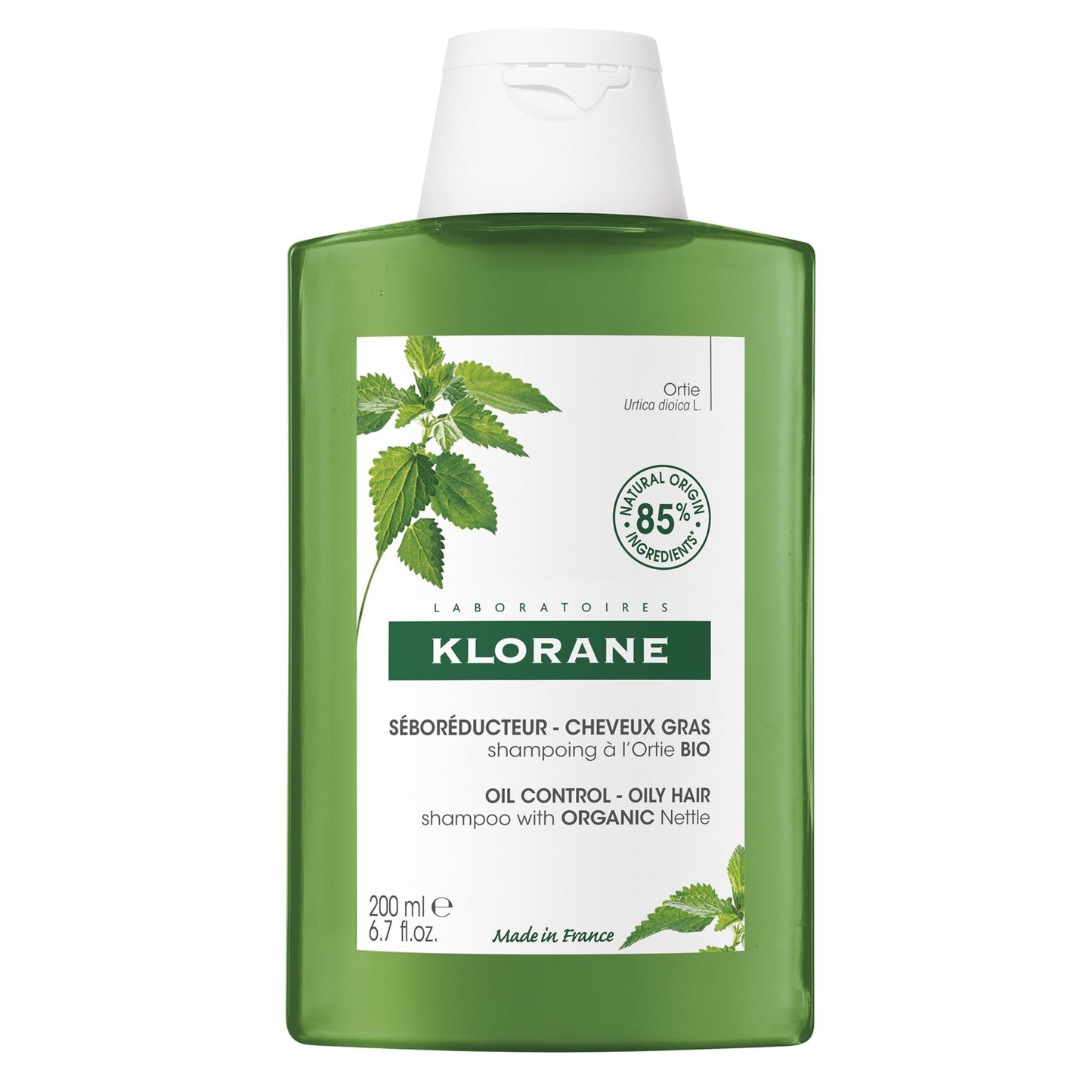 Klorane shampoo bottle with green label and white cap on a white background