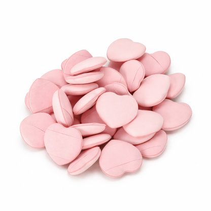 Pink heart-shaped candies on a white background