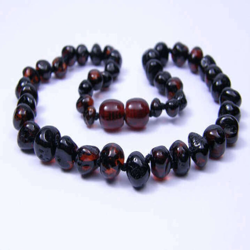 Two amber necklaces with black and red beads on a white background