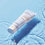 Cosrx sunscreen tube on a blue water background