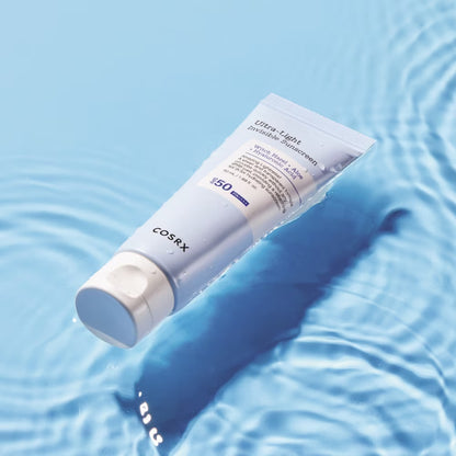 Cosrx sunscreen tube on a blue water background