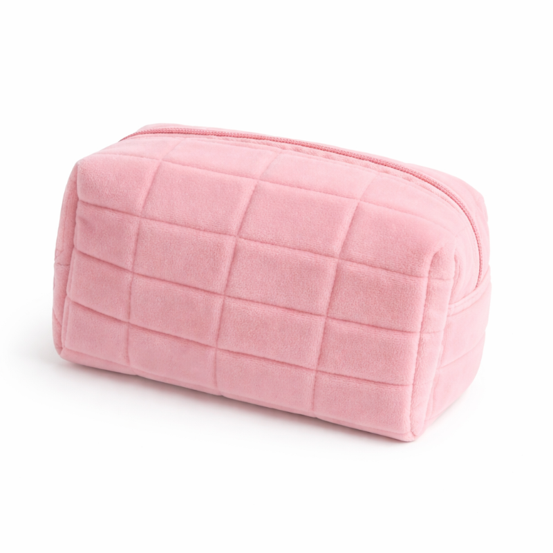 Pink quilted makeup bag on a white background