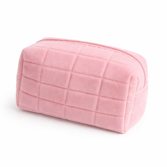 Pink quilted makeup bag on a white background