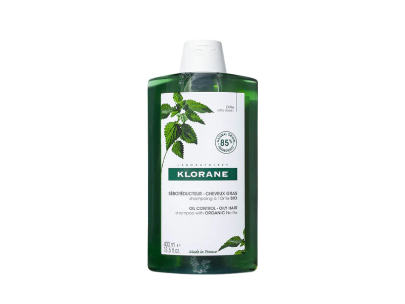 Klorane shampoo bottle with green label on a white background