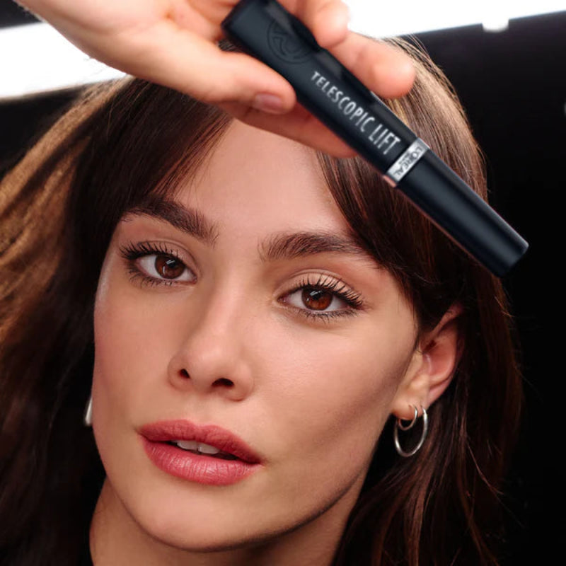 Woman holding a telescopic clip in front of her face