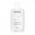 A bottle of NOREVA Sedax fluid designed for dermatological soothing care.